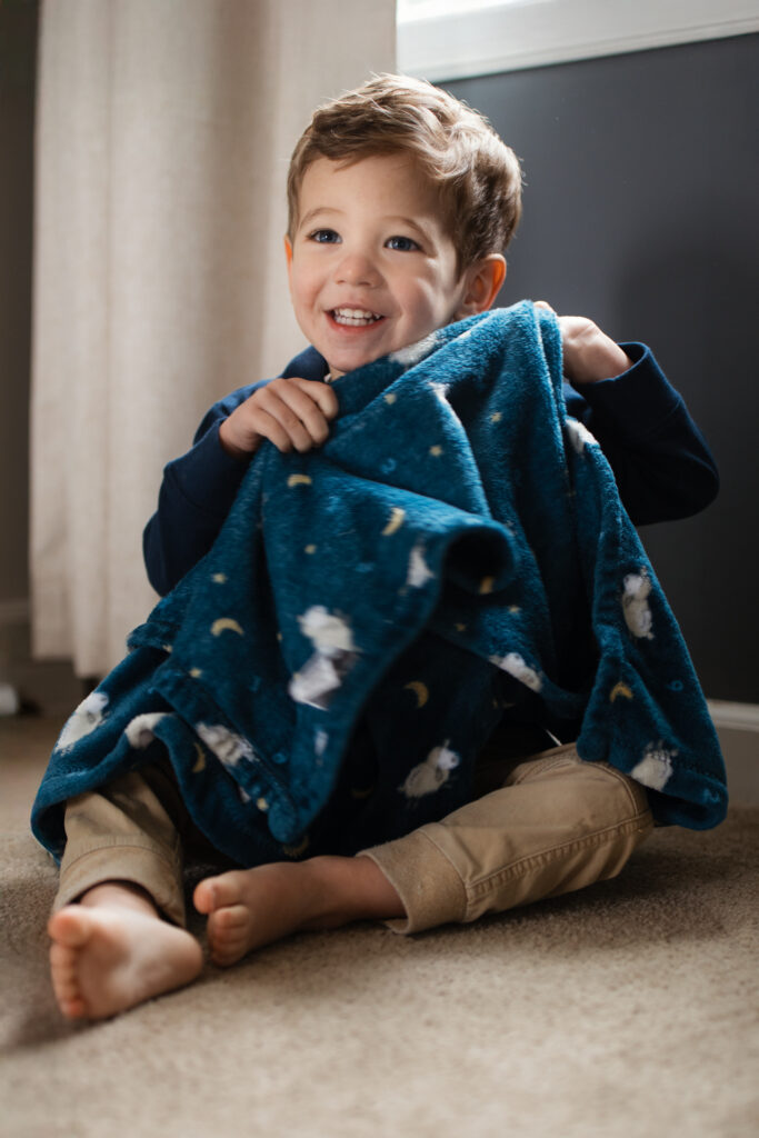 boy clutching his blanket