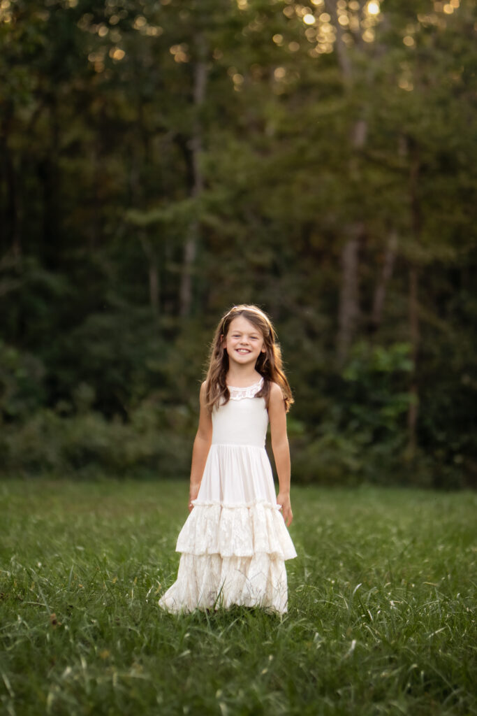 girl smiling in a dress in Veterans Park