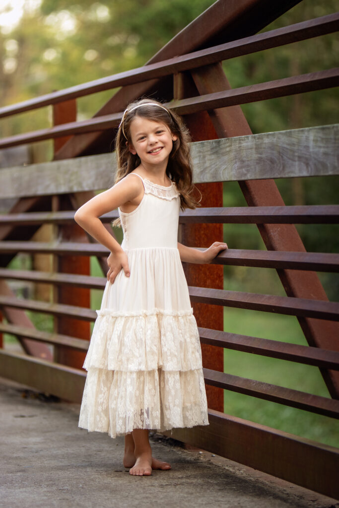 Girl smiling next to a fence at Veterans Park