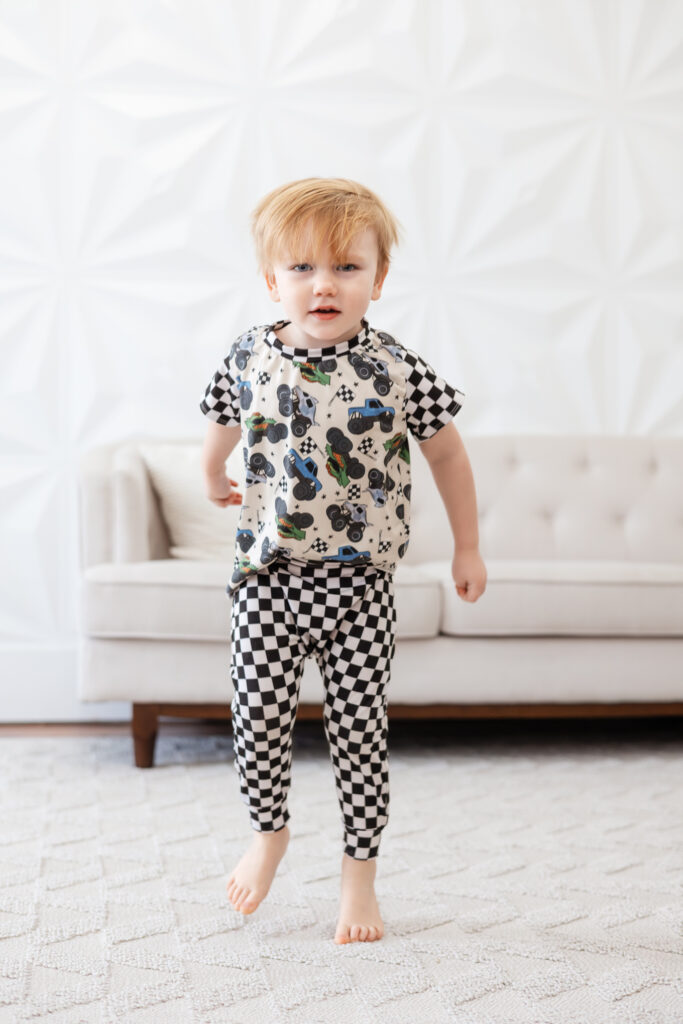 Little boy wearing a checkered outfit, hopping and growling