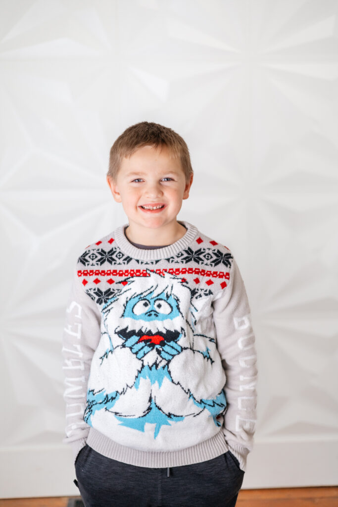 boy in a yeti sweater smiling